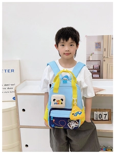 Close-up of blue kids backpack with cute panda motif and aircraft embroidery details