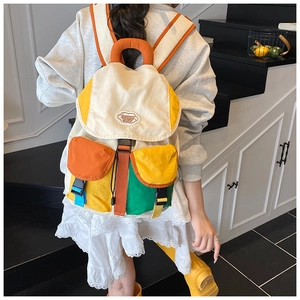 Detail of colorful multi-pocket backpack with clip buckles and adjustable straps