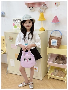 Detail view of purple rabbit backpack featuring cartoon eyes and 3D ears for toddlers