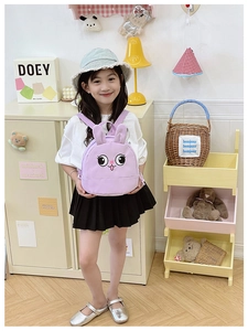 Detailed view of a purple rabbit toddler backpack in a cozy nursery room setting
