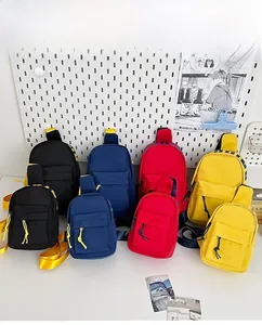 Mini crossbody chest bags shown in black, navy, red, and yellow across two sizes