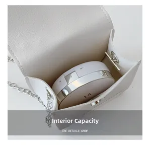 Detail of white mini bag interior capacity showing space for cushion foundation and lipstick