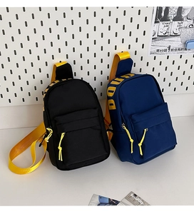 Detail of durable canvas chest bags in black and navy with bright yellow branded straps