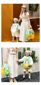 Close-up of kids contrast color nylon backpack with a cute cartoon frog pendant charm