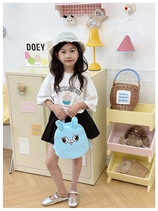 Detail of light blue plush bunny backpack featuring cute 3D ears and cartoon eyes