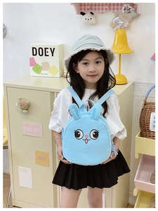 Detail view of light blue toddler backpack with cute 3D bunny ears and cartoon face