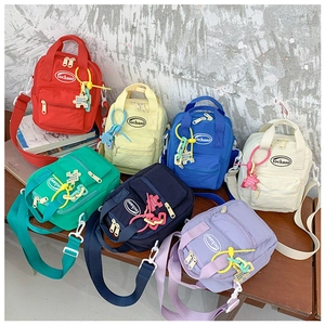 Vibrant canvas mini bags for children in multiple colors with cute decorative pendants
