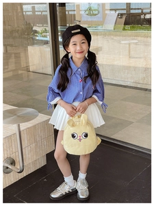 Toddler girl modeling cute yellow rabbit backpack with blue checkered shirt and skirt