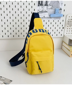 Detail of yellow nylon chest bag featuring blue DUDU lettering and dual zipper compartments