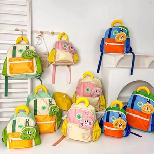Detailed view of kids cartoon backpacks with detachable animal charms and contrast colors