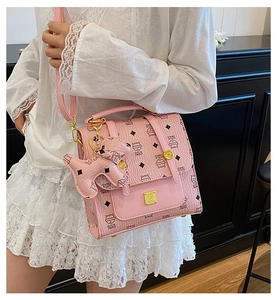 Pink fashion handbag with cat pattern, gold metal plaque and cute dog pendant detail