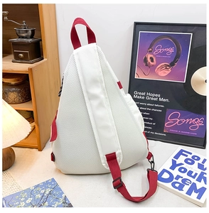 Detail of breathable mesh back and adjustable red shoulder strap on crossbody chest bag
