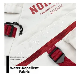 Close-up of white water-repellent fabric with red zipper and water droplets detail