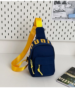 Detail of navy nylon mini crossbody bag with yellow STUDIO print and adjustable strap