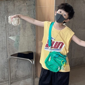 Kids minimalist solid color crossbody bag shown with trendy summer outfit and yellow tank top