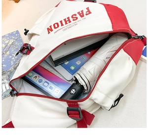 Top view of spacious interior of contrast color sling bag holding tablet and umbrella
