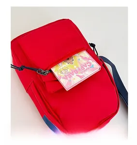 Detail of red crossbody bag with functional front zipper pocket for children's travel