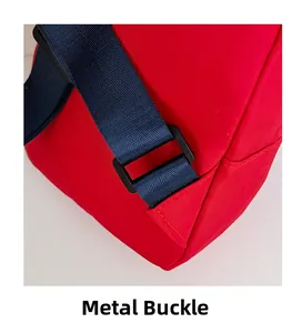 Detail showing the durable red nylon fabric and metal buckle hardware on a crossbody bag