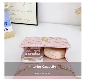 Internal view of the pink tweed mini bag showing space for cosmetics and gold lock