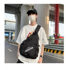 Detailed view of a black nylon crossbody chest bag with white 'FASHION' text on model