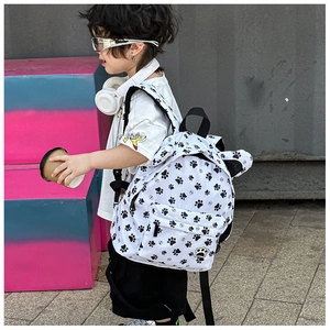 Side view of child wearing cartoon paw print backpack with 3D ears and wide straps