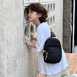 Minimalist black kids crossbody chest bag with yellow zippers for outdoor travel and leisure