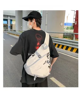Detail of white techwear chest bag with adjustable strap and fashion lettering