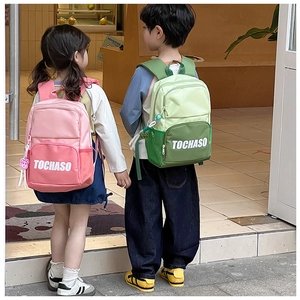 Detail of color-block kids backpacks featuring a large main pocket and side mesh pocket