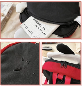Detailansicht von wasserfestem Canvas, Reißverschlüssen und roten Gurten am Welpenrucksack