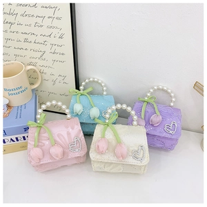Detail of floral lace mini bags with pearl handles and tulip charms in four pastel colors