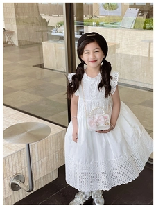 Detail of girls white lace sleeveless dress with intricate floral hollow embroidery