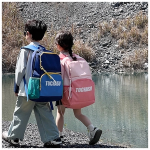 Detail view of large-capacity school backpacks with vibrant color blocking and side mesh pockets
