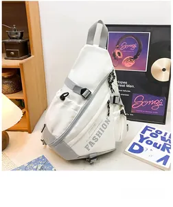 Detailed close-up of white crossbody bag with fashion lettering and gray adjustable straps