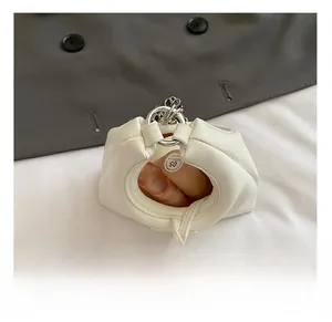 Detail view showing white mini drawstring bag interior holding a lipstick item