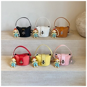Detailed view of mini bucket bags in six colors with woven texture and cute charms