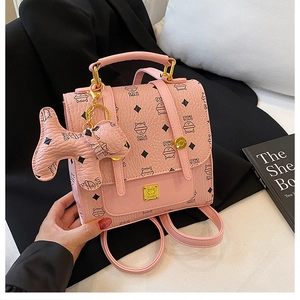 Detailed view of pink quilted cat print mini backpack with matching kitten charm and gold hardware
