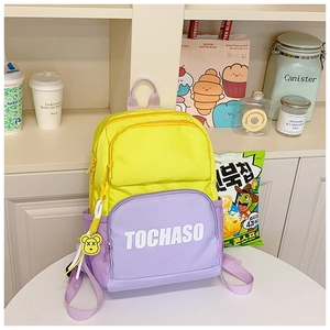 Close-up of contrast purple front pocket with TOCHASO text and yellow bear pendant