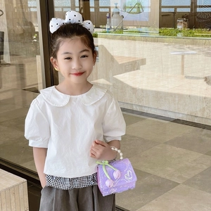 Elegant girl's white puff sleeve shirt with dark grey trousers and pearl lace handbag