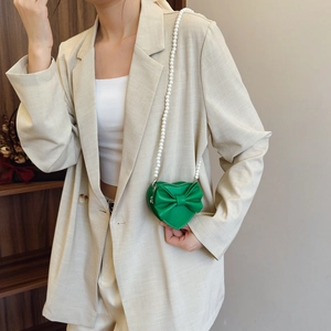 Green heart-shaped girls crossbody bag with bow detail and pearl chain strap