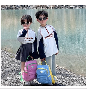 Outdoor view of vibrant pink and blue backpacks for kids with comfortable shoulder straps