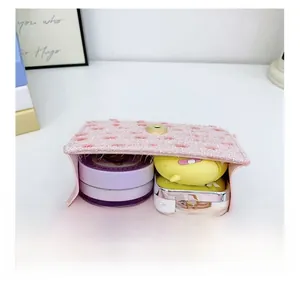 Internal capacity of pink tweed girl crossbody bag showing cosmetics inside