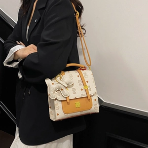 Women's chic beige lattice printed backpack with brown trim and elephant charm accessory