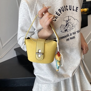 Stylish light yellow mini bucket bag with doll pendant and pearl chain decoration