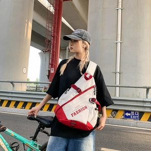 Red and white contrast crossbody chest bag with adjustable strap and multiple zip pockets