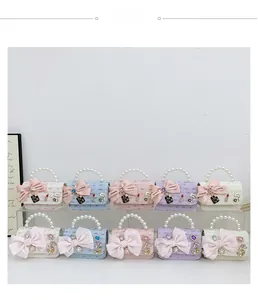 Detail of tweed mini bags with pearl handles and decorative bow accents in five colors