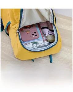 Detail view of the spacious yellow and blue backpack interior with smooth zippers