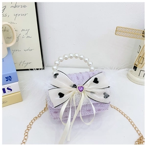 Detail of purple tweed girl bag with pearl handle, bow, feather and chain strap