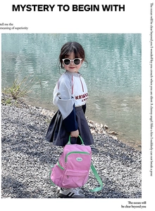 Girl wearing pink candy-colored school backpack outdoors with casual hoodie and skirt