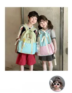 Lightweight school backpacks in mint and sky blue shown on children in a bright interior