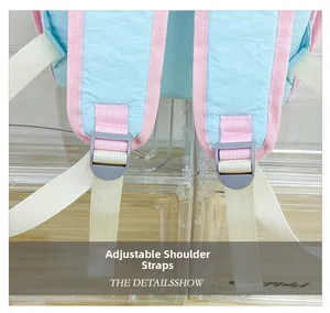 Detail of adjustable pink padded shoulder straps with gray plastic buckle on kids backpack